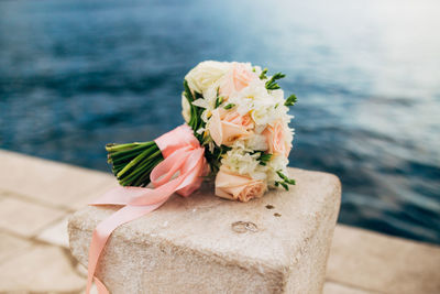 Close-up of rose bouquet against sea