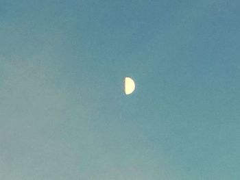 Low angle view of moon against clear sky at night