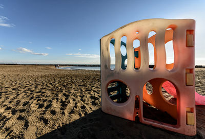 Lifeguard hut on beach against sky