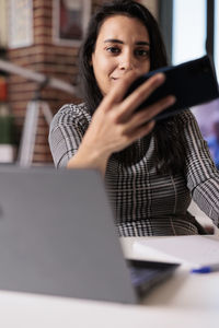 Young woman using laptop at office