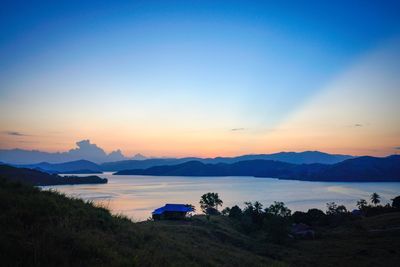 Scenic view of lake against sky during sunset