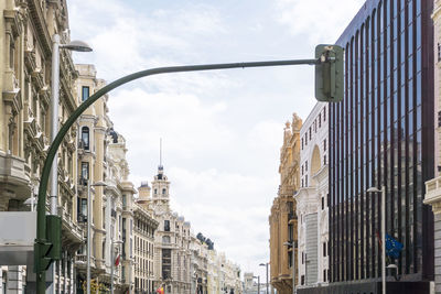 Low angle view of stoplight against buildings