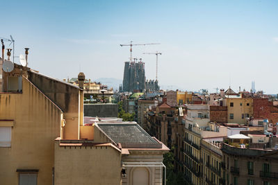 Houses and buildings in city against sky