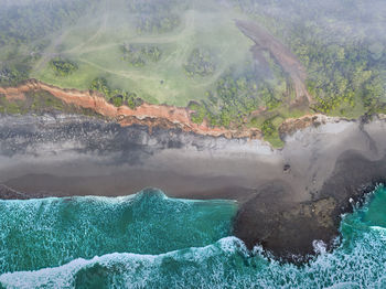 Beach view from the air with calm waves during the day in north bengkulu, indonesia