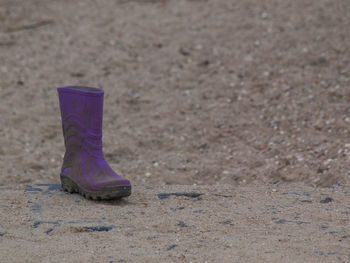 Close-up of shoes on sand