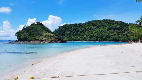 Scenic view of beach against blue sky