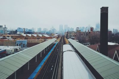 High angle view of public transit system with city skyline