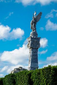 Low angle view of statue against cloudy sky