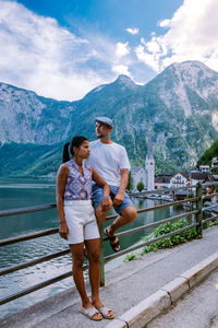 Full length of woman standing on mountain against sky