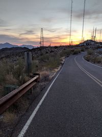 Empty road against sky during sunset
