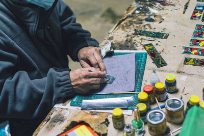 Local artist from ruta de las flores, el salvador working on handmade colorful souvenirs