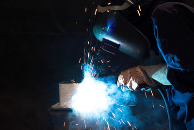 Man welding metal at factory