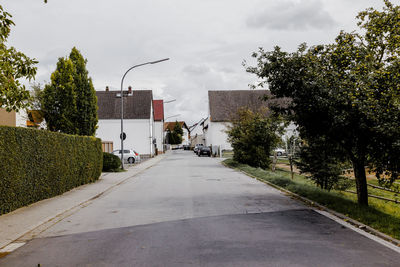 Empty road along buildings