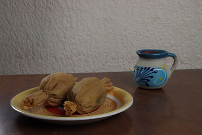 Close-up of breakfast on table against wall