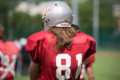 Rear view of man with red umbrella