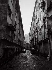 Narrow street amidst buildings against sky