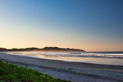 Scenic view of beach against clear sky