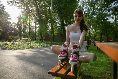 Portrait of young woman sitting on road