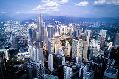 High angle view of modern buildings in city against sky