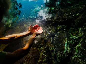 Low section of woman relaxing on rock