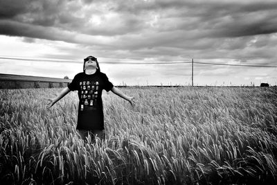 Rear view of girl standing on grassy field