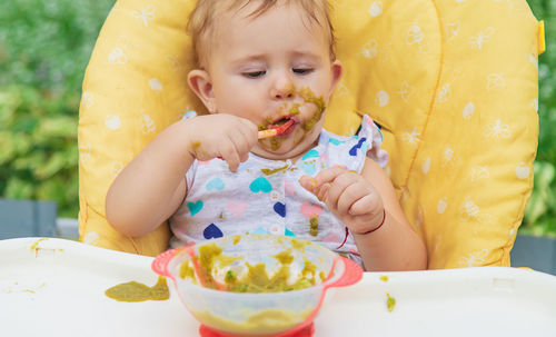 Close-up of cute girl eating food