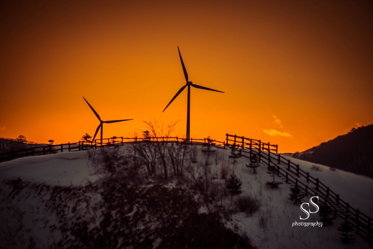 VIEW OF WIND TURBINES DURING SUNSET