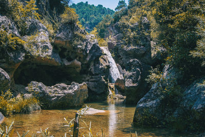 Scenic view of lake against rock formation