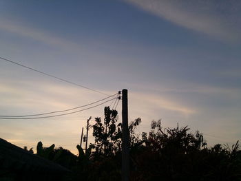 Low angle view of silhouette trees against sky at sunset