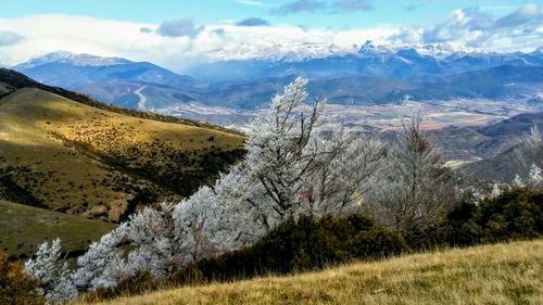 Scenic view of landscape and mountains against sky