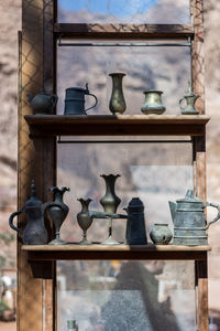 Close-up of objects on window of building