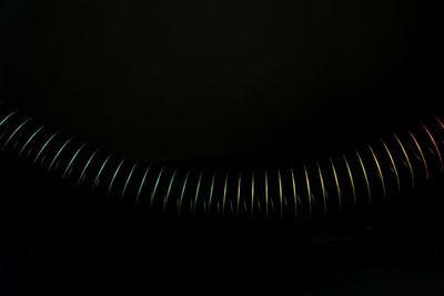 Close-up of spiral metal against black background