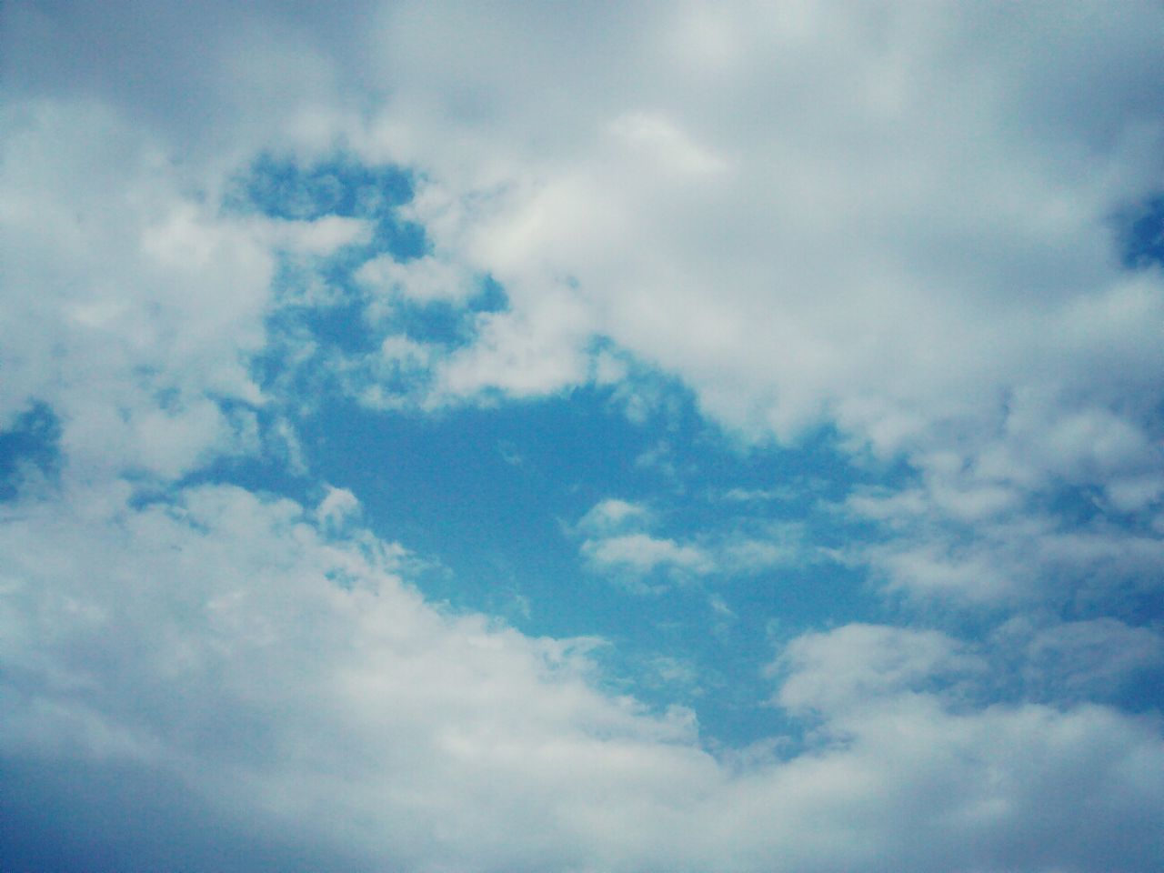 sky, cloud - sky, low angle view, sky only, beauty in nature, cloudy, tranquility, scenics, backgrounds, nature, cloudscape, full frame, tranquil scene, cloud, blue, idyllic, weather, white color, outdoors, day