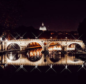 Illuminated building against sky at night