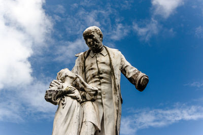 Low angle view of statue against blue sky