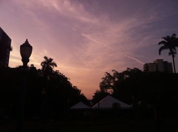 Low angle view of silhouette trees against sky at dusk