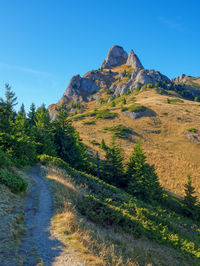 Scenic view of mountains against blue sky