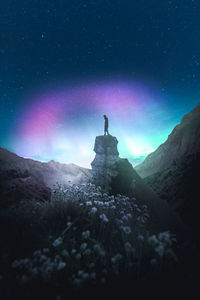 Low angle view of rock formation against sky at night