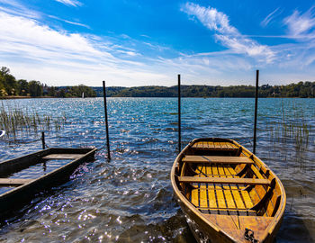 Scenic view of wooden boat in sea against sky