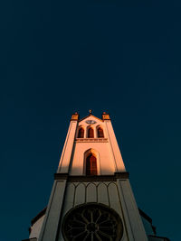 Low angle view of building against clear sky at night