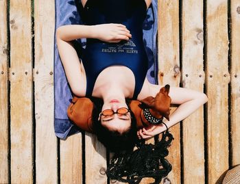 Portrait of friends lying on wood