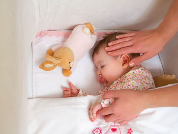 High angle view of mother and baby on bed