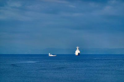 Sailboat sailing on sea against sky