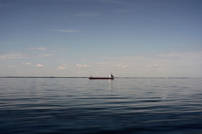 Sailboat in sea against sky