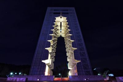 Low angle view of illuminated building at night