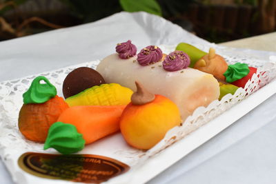 Close-up of served fruits in plate on table