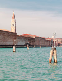 View of boats in sea against buildings