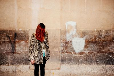 Woman standing against wall