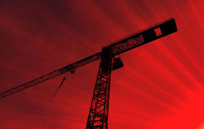 Red high construction crane on a building site, oblique picture of an abstract image effect,