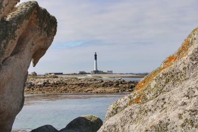 Rock formations by sea against sky